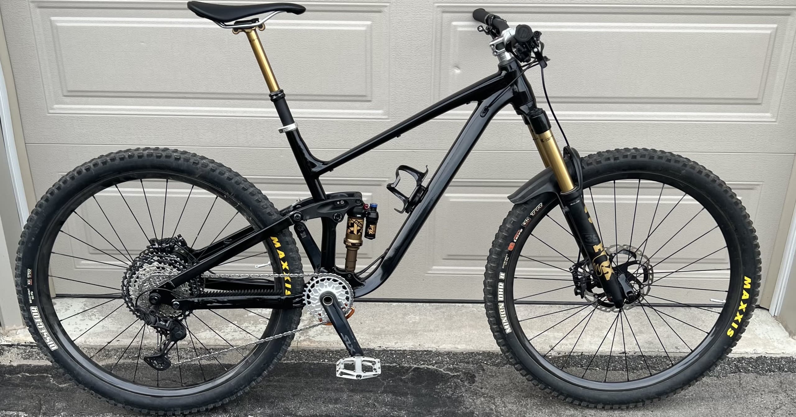 Black full-suspension mountain bike with gold accents